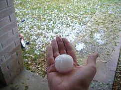 Hailstone held in hand after a storm