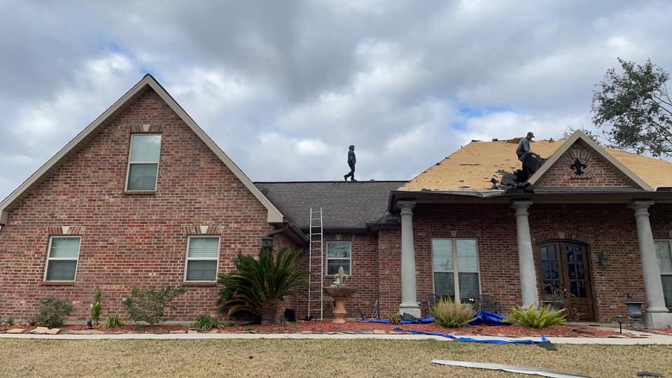 Guardian crew tearing off an old roof